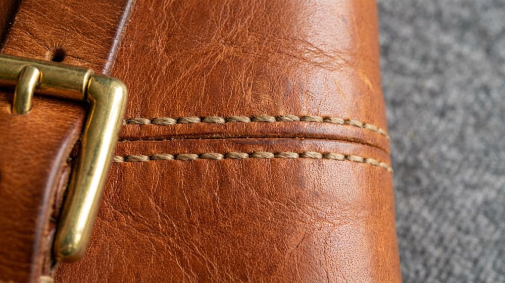close-up-of-satchel-stitching-full-grain-leather-texture-brass-hardware