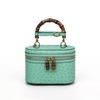 Genuine Ostrich Leather Women's Oval Cosmetic Crossbody with Bamboo Handle